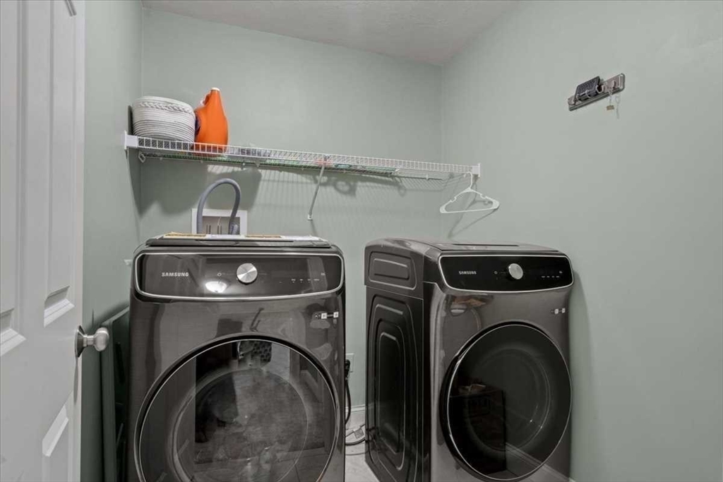 28 McIntosh Drive, Unit 22 Stow, MA 01775 - Photo 32 of 38 a utility room with dryer and washer