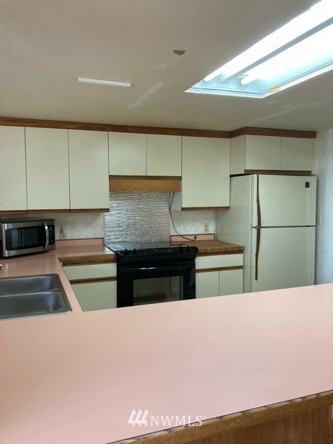 176 Boyd Road Randle, WA 98377 - Photo 7 of 25 a kitchen with stainless steel appliances granite countertop a sink and a refrigerator