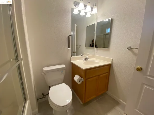a bathroom with a sink a toilet and mirror