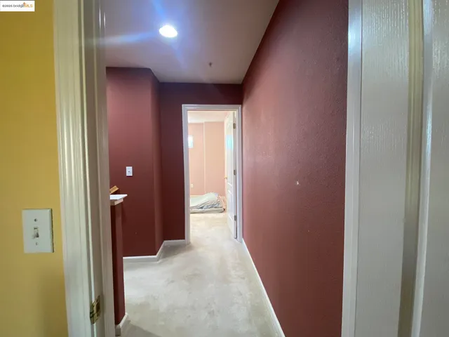a view of a hallway with wooden shelves