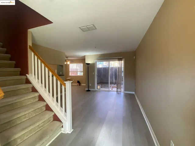 a view of a hallway view with wooden floor and staircase