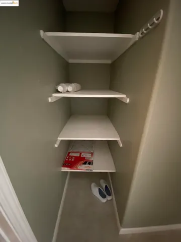 a room with toys and a potted plant on a bookshelf