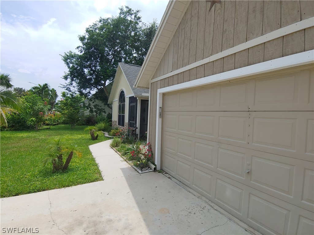 17496 Lebanon Road Fort Myers, FL 33967 - Photo 3 of 21 a view of backyard with potted plants and large tree