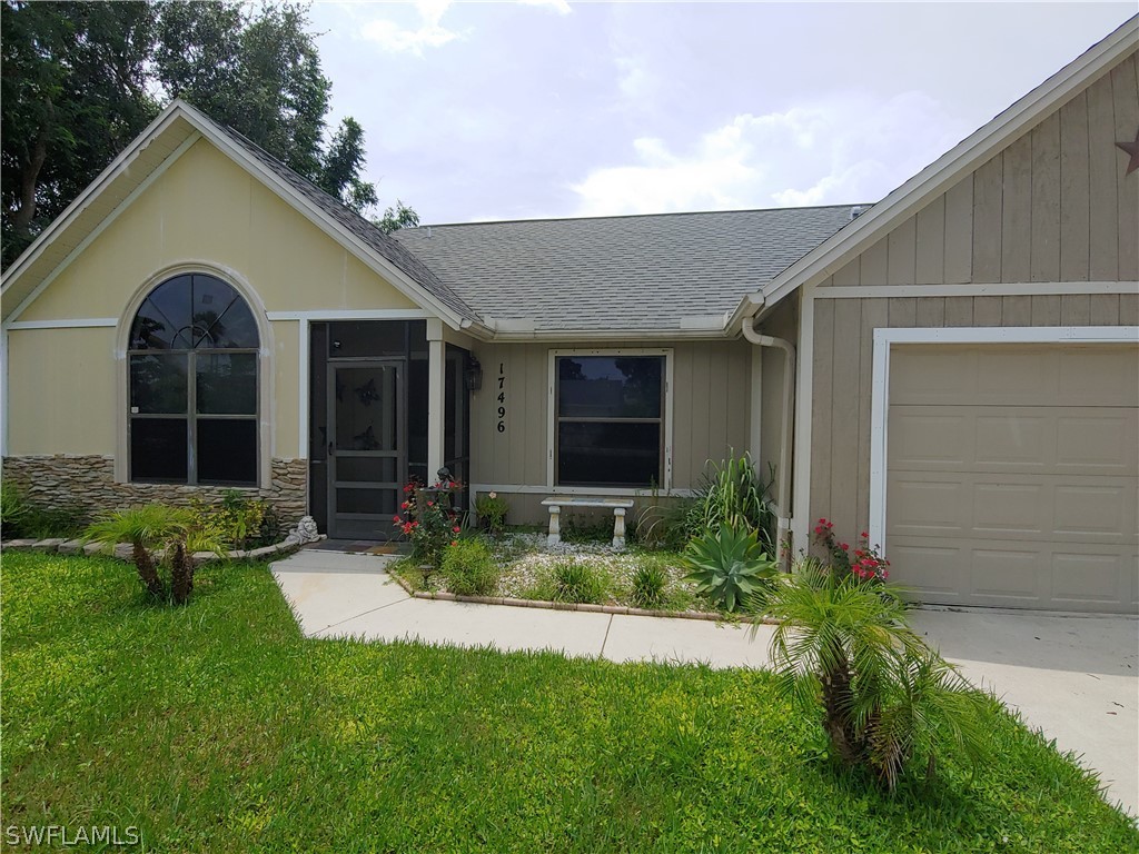 17496 Lebanon Road Fort Myers, FL 33967 - Photo 4 of 21 a front view of a house with a yard and porch