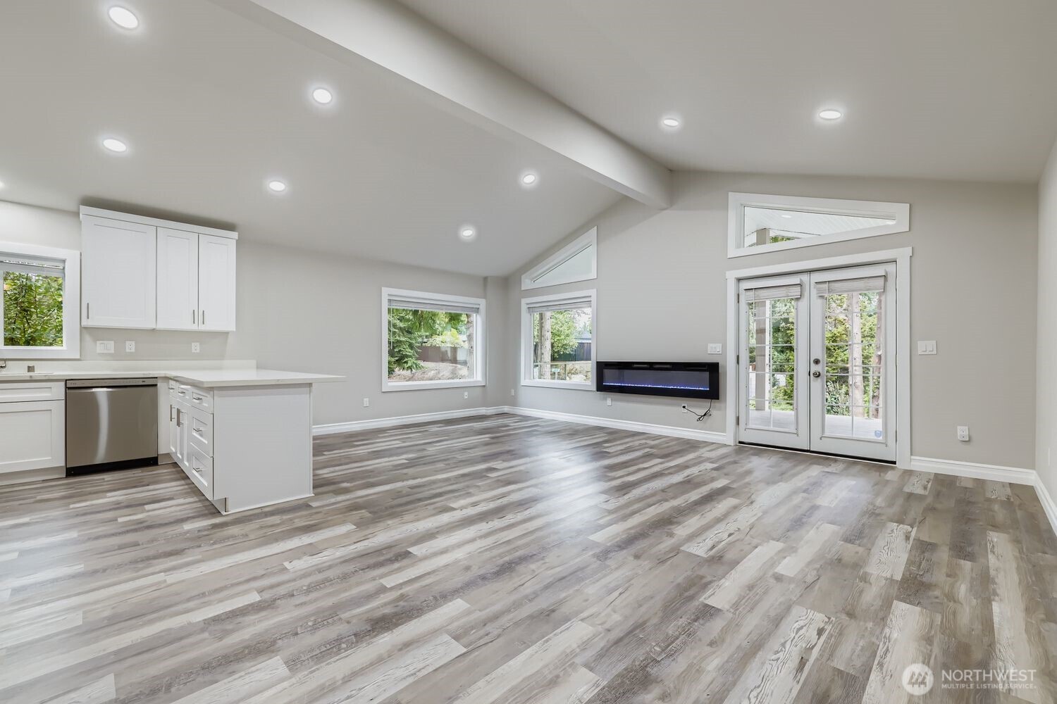 8912 229th Place Southwest, Unit B Edmonds, WA 98026 - Photo 2 of 25 an empty room with wooden floor and windows