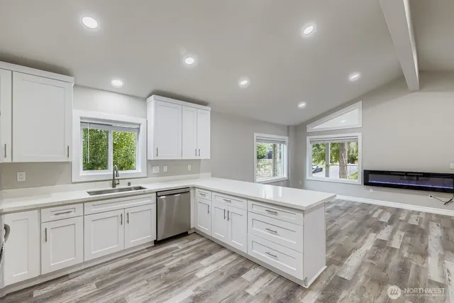 a large white kitchen with a large window
