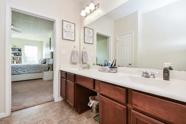 a spacious bedroom with a bed and a chandelier