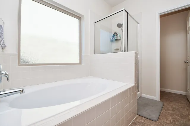 a en suite bathroom with double vanity sinks a vanity and a mirror