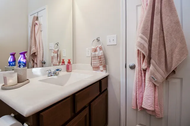 a bedroom with a bed and a flat tv screen on a dresser