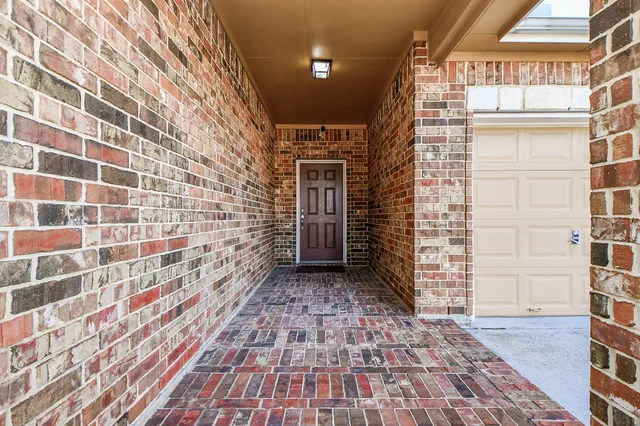 a view of a brick house with a street