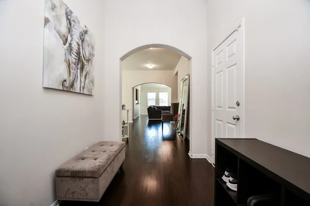 a view of a livingroom with wooden floor and a chandelier