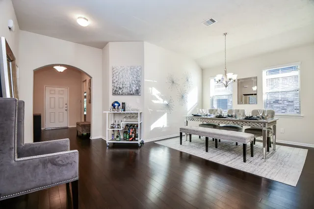 an aerial view of residential houses with outdoor space and ocean view