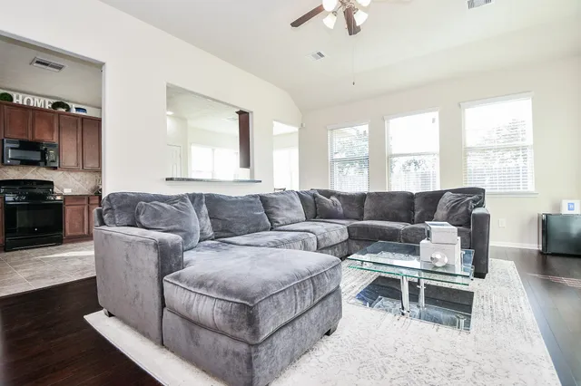 a living room with fireplace furniture and a wooden floor