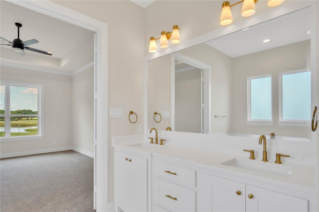 1028 Henry Way Springtown, TX 76082 - Photo 18 of 40 a bathroom with a sink vanity and mirror