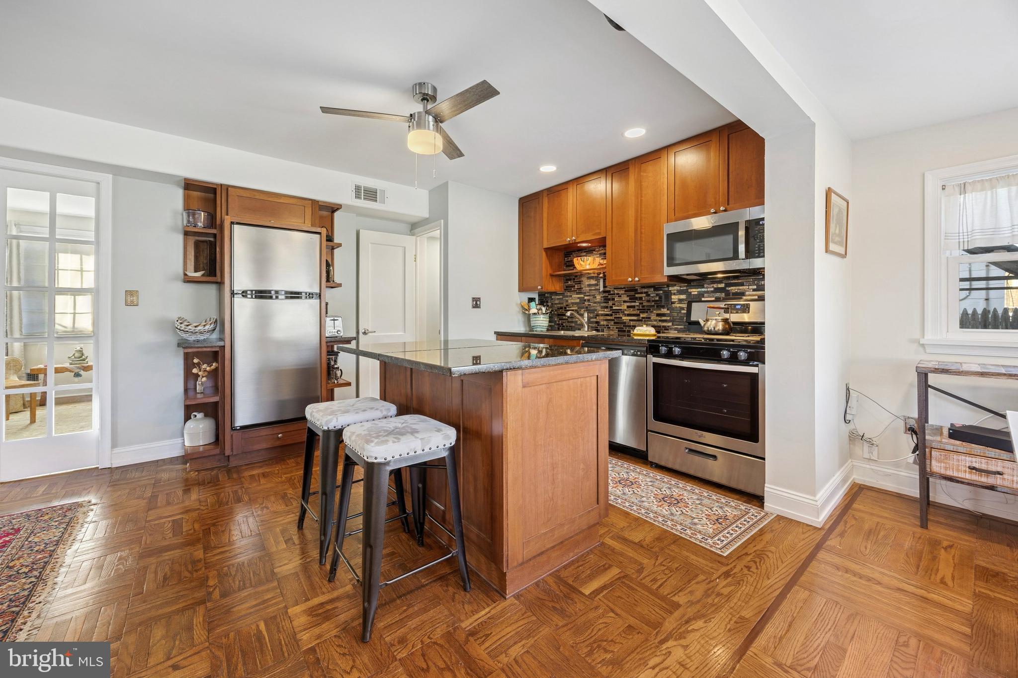 1155 Easton Road Abington, PA 19001 - Photo 10 of 35 a large kitchen with stainless steel appliances kitchen island granite countertop a table chairs sink and cabinets