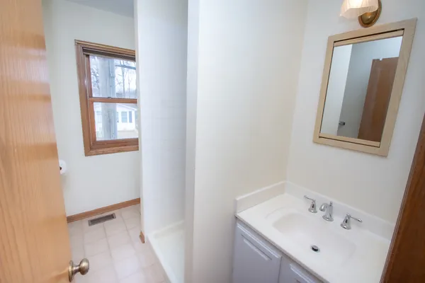 a bathroom with a sink a mirror and vanity