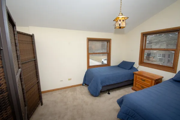 a bedroom with bed and window