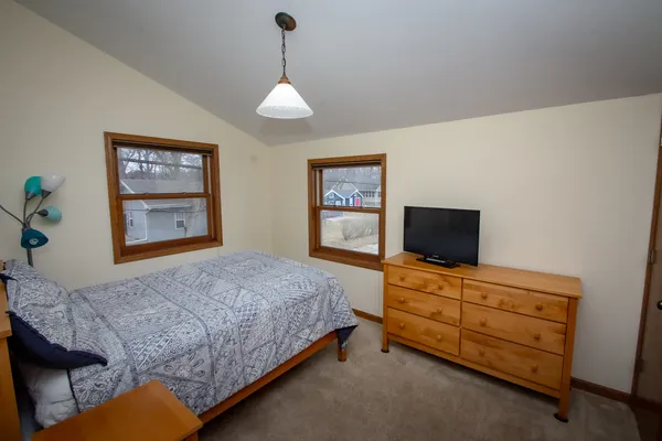 a bedroom with a bed and a flat screen tv