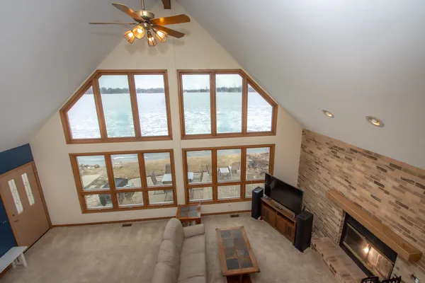a view of an empty room with a fireplace and a window