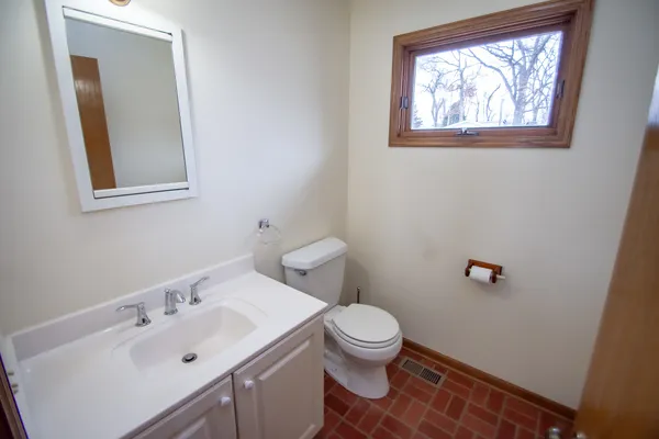 a white toilet sitting next to a bathroom sink