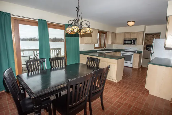 a view of a dining room with furniture a chandelier and wooden floor