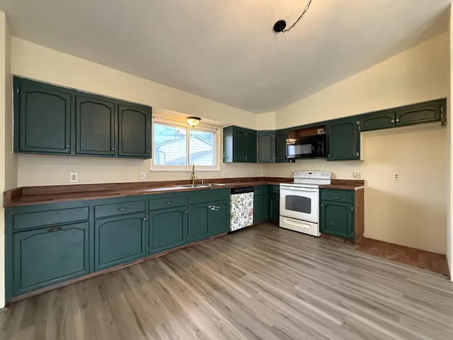 a kitchen with stainless steel appliances granite countertop a sink and cabinets