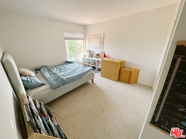 a bedroom with bed and a window