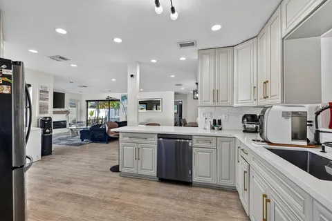 a kitchen with stainless steel appliances a refrigerator stove and cabinets