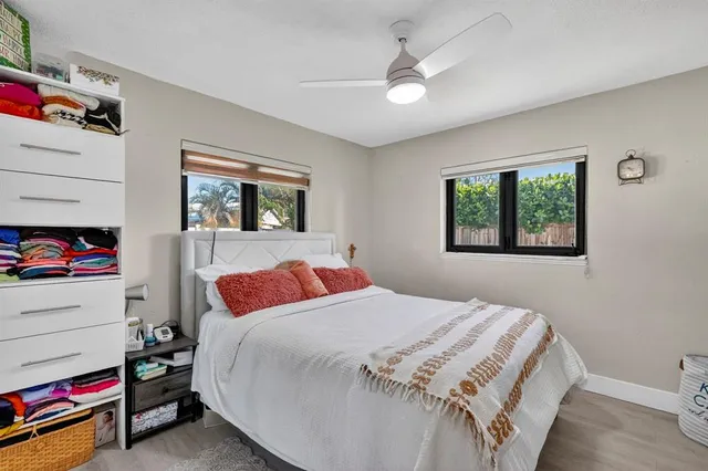 a spacious bedroom with a large bed and a chandelier