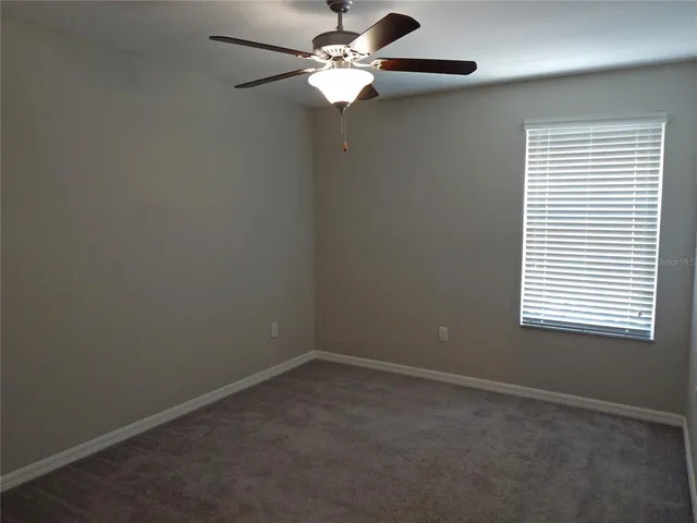 a view of an empty room with a fan