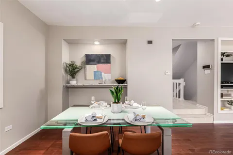 a dining room with furniture and wooden floor
