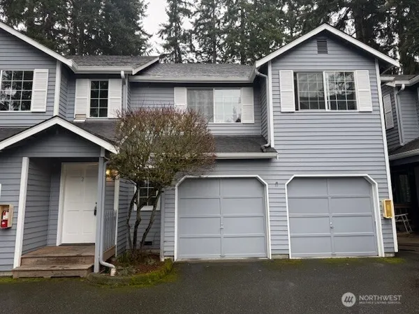 a front view of a house with a garage