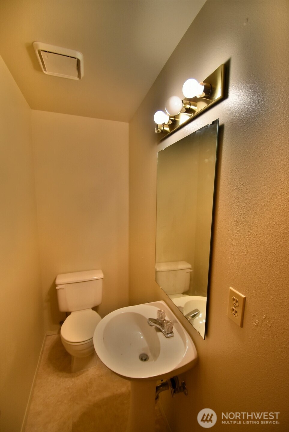 7616 200th Street Southwest, Unit 2 Edmonds, WA 98026 - Photo 5 of 12 a bathroom with a sink a toilet and mirror