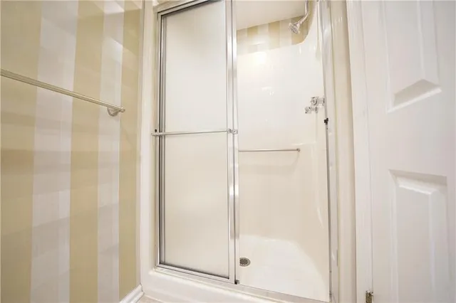 a bathroom with a glass shower door