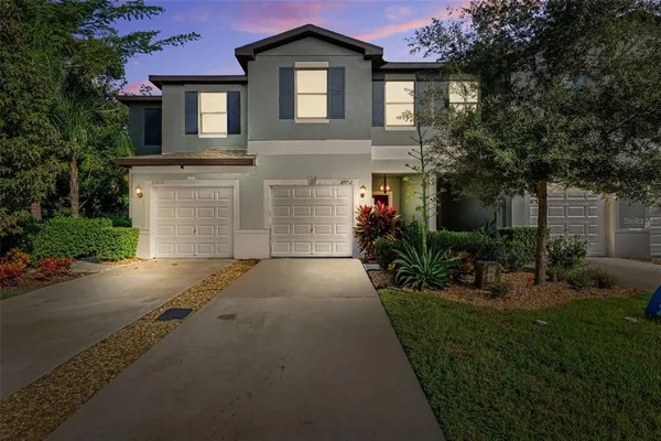 a front view of a house with a yard and garage