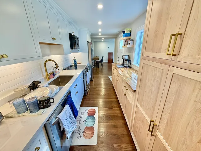 a view of living room with furniture and a fireplace