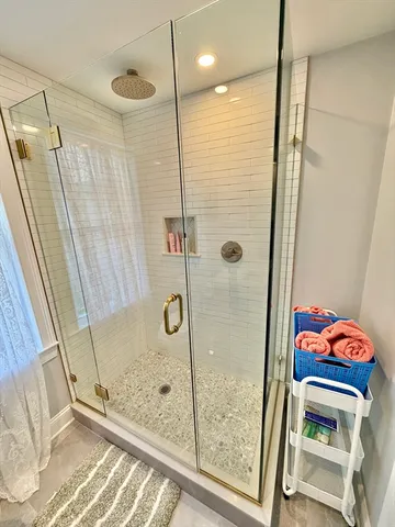 a bathroom with a shower and a sink