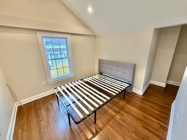 a view of a room with wooden floor