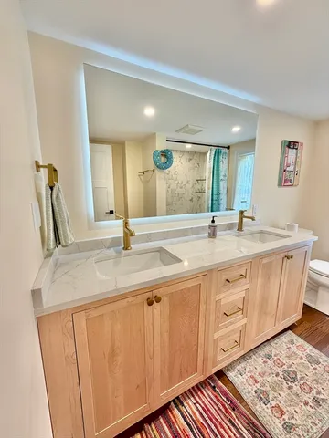 a bathroom with a double vanity sink and a mirror