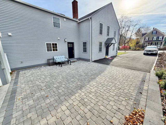 a backyard of a house with fire pit and couch