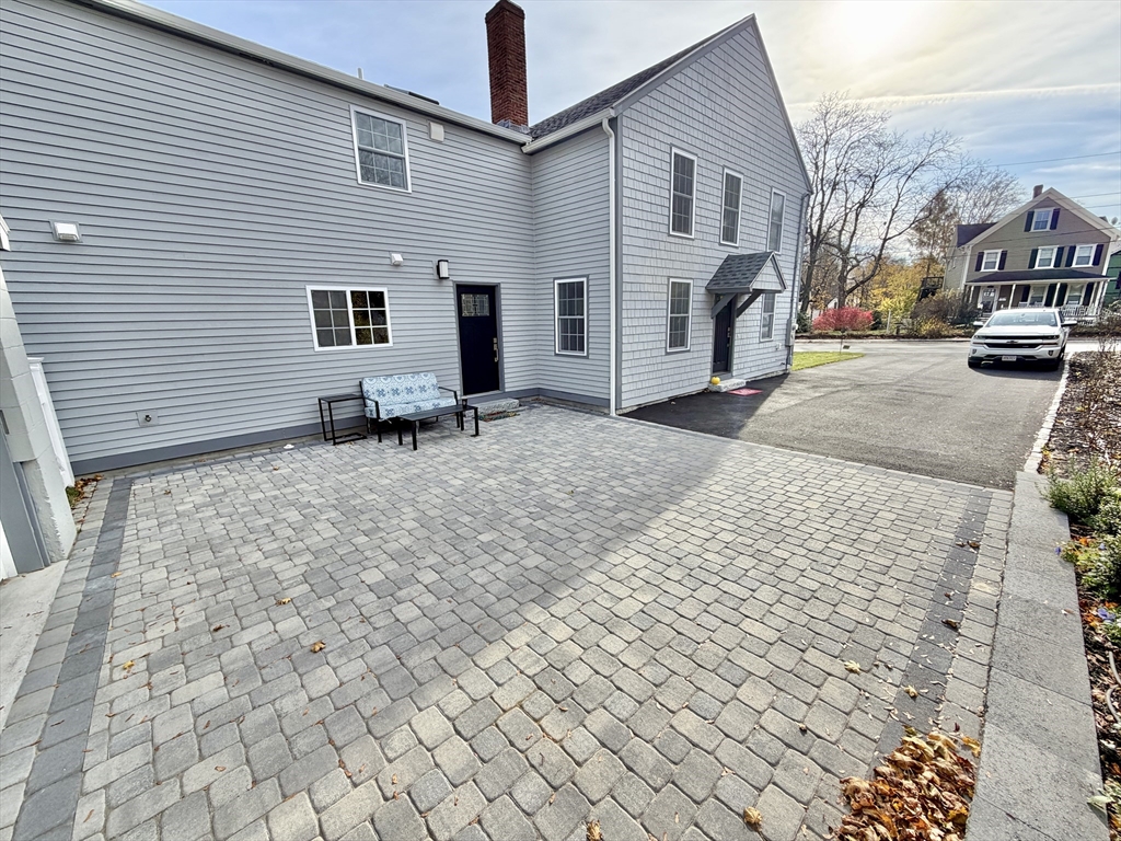 48 Springs Road, Unit RD Bedford, MA 01730 - Photo 24 of 27 a backyard of a house with fire pit and couch