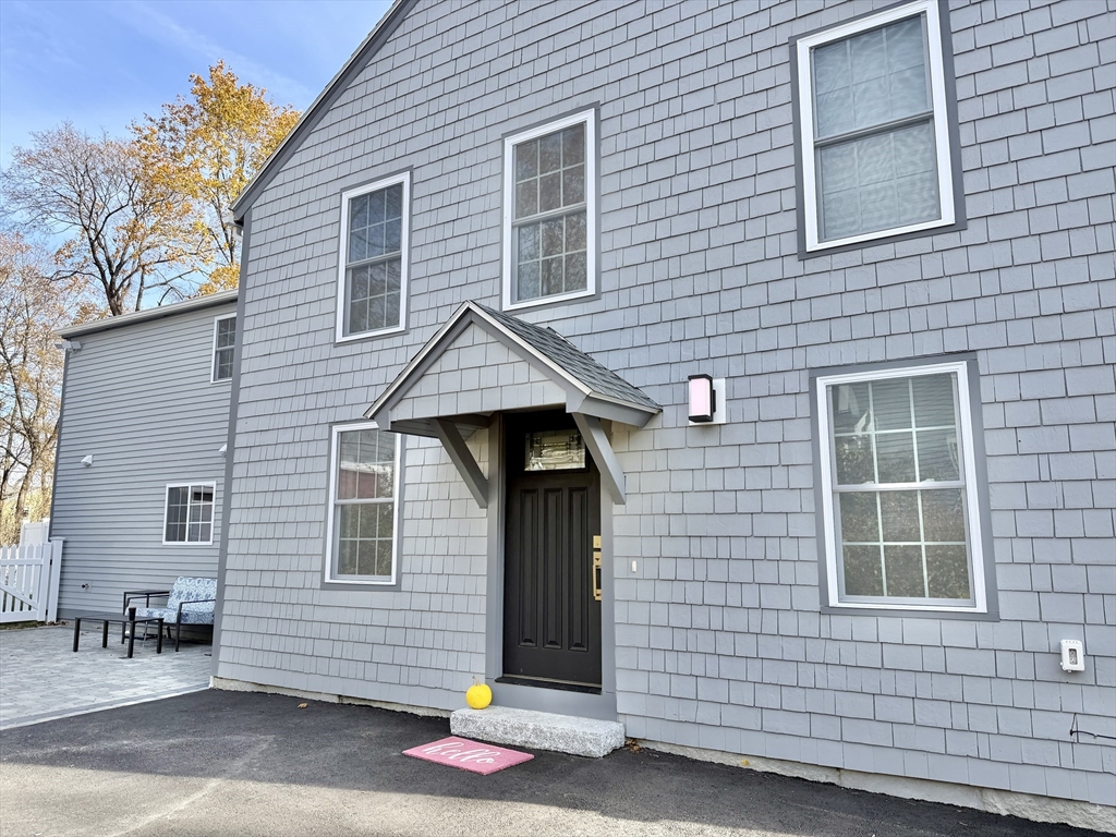 48 Springs Road, Unit RD Bedford, MA 01730 - Photo 4 of 27 a front view of a house with garage
