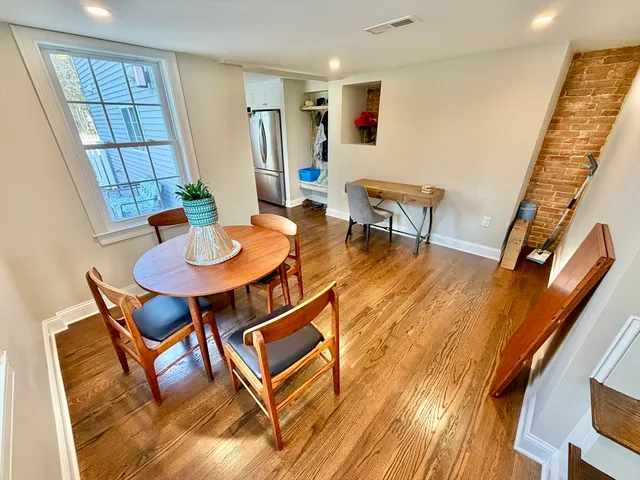 a dining room with furniture and wooden floor