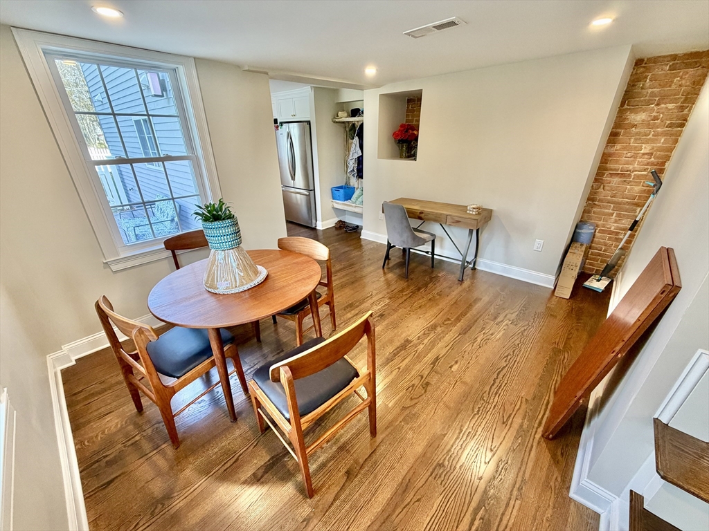 48 Springs Road, Unit RD Bedford, MA 01730 - Photo 7 of 27 a dining room with furniture and wooden floor