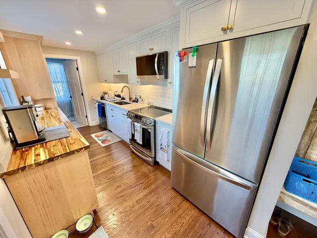 a kitchen with stainless steel appliances a refrigerator and a stove
