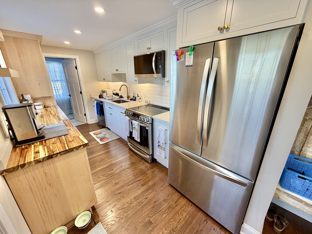 48 Springs Road, Unit RD Bedford, MA 01730 - Photo 9 of 27 a kitchen with stainless steel appliances a refrigerator and a stove