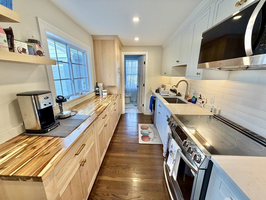 48 Springs Road, Unit RD Bedford, MA 01730 - Photo 10 of 27 a kitchen with stainless steel appliances granite countertop a stove and a sink