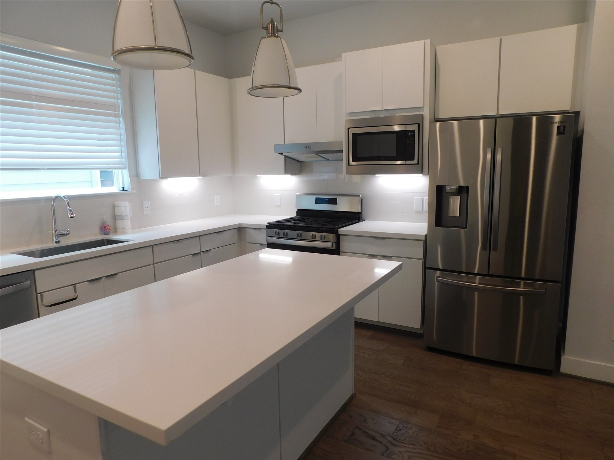 4223 Eli Street Houston, TX 77007 - Photo 11 of 46 a kitchen with stainless steel appliances a refrigerator sink and microwave