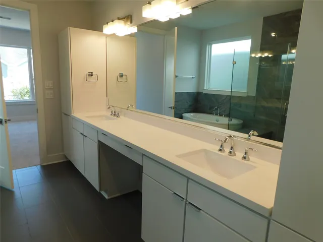 a bathroom with a sink double vanity and a mirror