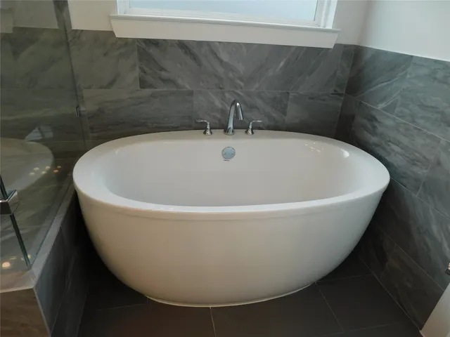 a white bath tub sitting in a bathroom